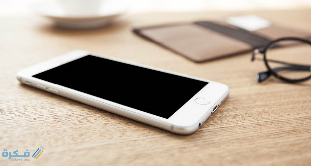 حل مشكلة انطفاء الهاتف وعدم اشتغاله مرة اخرى 1 white cell phone laying on wood table black frame glasses